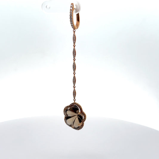 Floral shaped smoky topaz gem hanging from a chain made from diamonds with a rose gold lock earring
